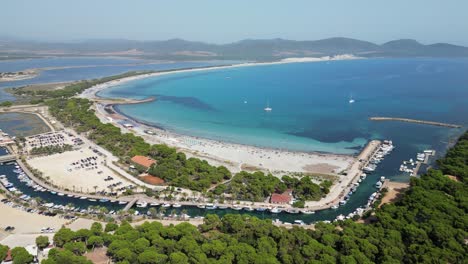 Spiaggia-di-Porto-Pino-Beach,-Port,-Boats-and-Bay-in-Sardinia,-Italy---4k-Aerial