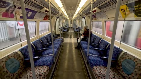 12-December-2022---Inside-View-Of-Northbound-Jubilee-Line-Train-Carriage-With-Elderly-Passenger-Seated