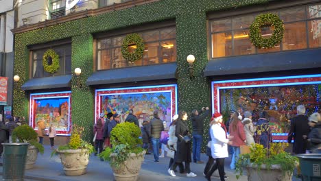 Shot-of-Macy's-shop-exterior-beautifully-decorated-with-tourists-walking-by-during-christmas-festivities-in-Manhattan,-New-York,-USA-at-daytime