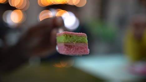Close-up-shot-colorful-cake-from-Street-food-market-with-blurred-backgroun