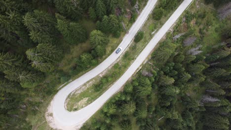 Aerial-View-of-Car-traveling-through-Curvy-Mountain-Road