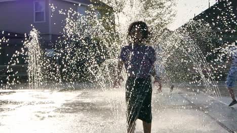 Little-Girl-jumps-and-plays-in-a-water-fountain-in-slow-motion
