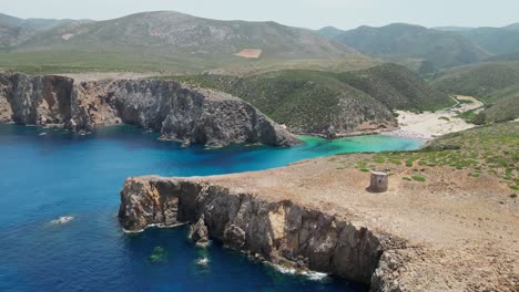 Cala-Domestica-Beach-and-Blue-Cove-in-Sardinia,-Italy---4k-Aerial-Circling