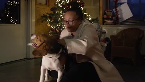 Black-woman-petting-her-dog-during-christmas