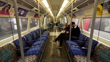 12-December-2022---Inside-View-Of-Northbound-Jubilee-Line-Train-Carriage-With-Passengers-Seated