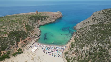 Cala-Domestica-Sandy-Beach-and-Blue-Cove-in-Sardinia,-Italy---4k-Aerial