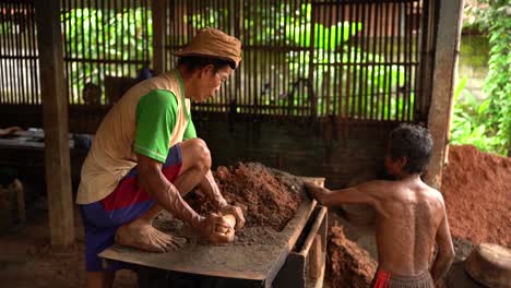 The-process-of-preparing-clay-dough-for-making-pottery-using-a-grinding-machine