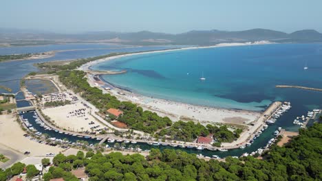 Spiaggia-di-Porto-Pino-Beach,-Port,-Boats-and-Bay-in-Sardinia,-Italy---4k-Aerial-Circling