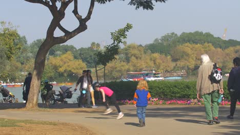 -Families-strolling-in-the-Park-with-children-and-dogs-on-a-sunny-day