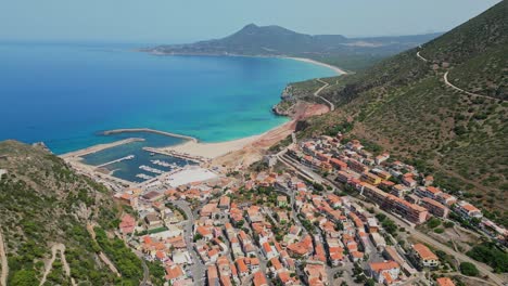 Buggerru-mining-and-coastal-village-at-West-Coast-of-Sardinia,-Italy---4k-Aerial