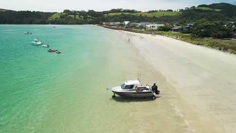 Amphibious-fishing-boat-driving-from-the-beach-into-the-water-at-high-tide