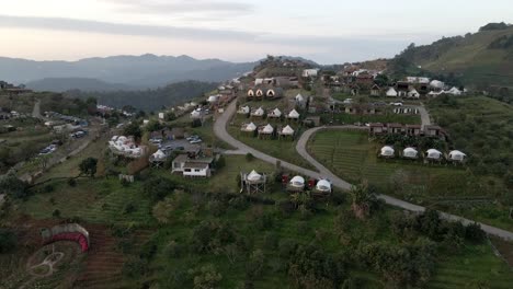 Pan-down-drone-shot-above-the-camp-village-in-Thailand's-mountains