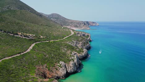 Coastal-Road-along-Rocky-Cliffs-and-Blue-Sea-at-West-Coast-Sardinia,-Italy---4k-Aerial