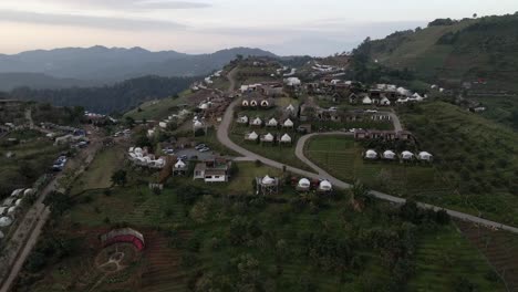 Reveal-back-shot-of-the-camp-village-during-the-sunrise-on-the-hill-in-Thailand