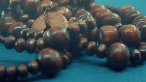 Macro-shot-of-a-wooden-round-beads-necklace-with-coin-medallion
