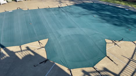 Aerial-view-swimming-pool-covered-for-the-winter-in-suburban-neighborhood-winterized