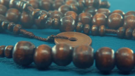 Macro-pan-shot-of-a-wooden-round-beads-necklace-with-coin-medallion