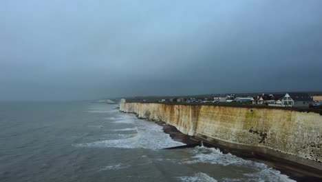 Dark-grey-storm-clouds-in-sky-over-cliffs-on-coast-of-England-in-winter