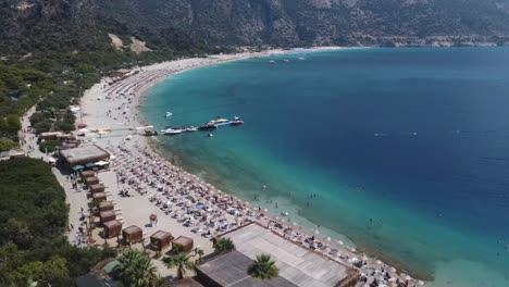 Aerial-view-of-Oludeniz-beach-and-its-crystal-clear-waters,-summer-vacation-spot