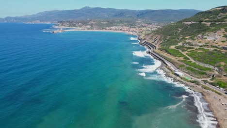 Scenic-Coastal-Road-along-Blue-Sea-to-Bosa-Marina,-Sardinia,-Italy---4k-Aerial