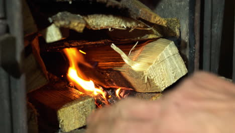 Burning-firewood-in-fireplace-for-heating-the-house,-heating-season