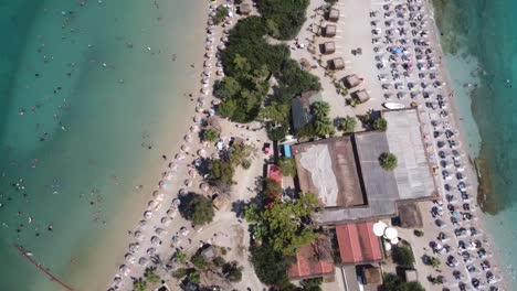 Aerial-view-of-beach-resort-surrounded-by-crystal-waters-in-Oludeniz-on-the-Turquoise-coast-of-Turkey