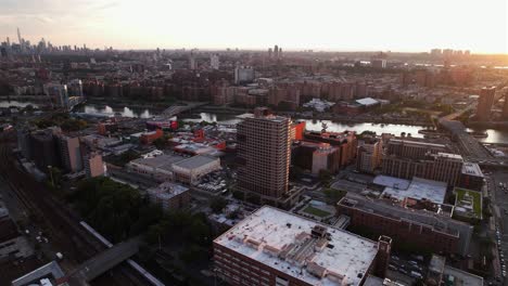 Aerial-view-around-the-tallest-building-in-Bronx,-the-425-Grand-Concourse-building,-sunny-evening-in-New-York---orbit,-drone-shot