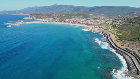 Coastal-Road-and-Blue-Bay-at-Bosa-Marina,-Sardinia,-Italy---4k-Aerial