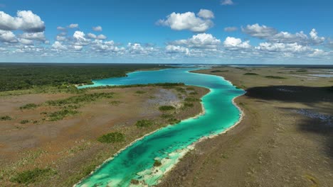 Rising-over-the-Bacalar-rapids,-sunny-day-in-Quintana-roo,-Mexico---Aerial-view