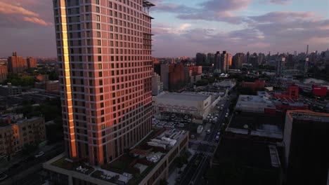 Aerial-view-circing-around-the-425-Grand-Concourse-building,-sunset-in-Bronx,-NY