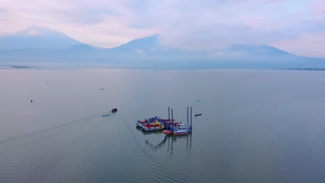Aerial-view-of-dredger-boat-on-the-lake-with-boats-passing-by