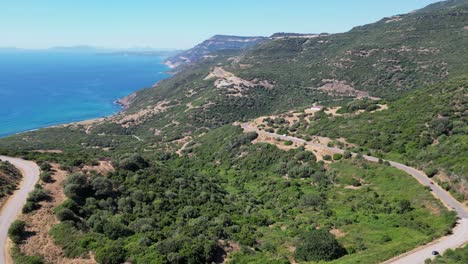 Coastal-Road-at-West-Coast-of-Sardinia-between-Blue-Sea-and-Green-Mountains---4k-Aerial