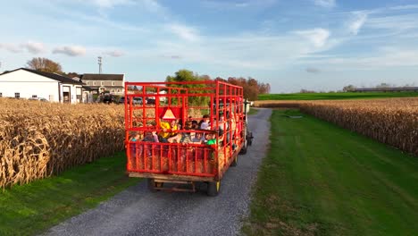 Children-enjoy-ride-on-hay-wagon-with-tractor
