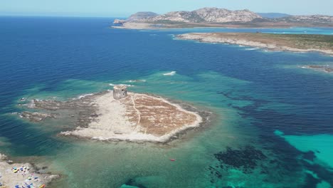 Spiaggia-della-Pelosetta-Beach-and-La-Pelosa-island-tower-in-Sardinia,-Italy---4k-Aerial