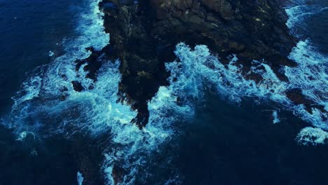 Overhead-Shot-Of-Small-Waves-Splashing-Softly-On-Rocks-In-Los-Cristianos,-Tenerife