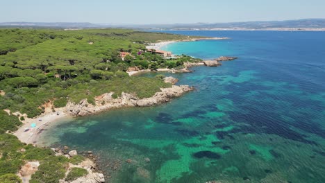 Small-coves-and-luxury-hotel-resort-at-Cala-Spinosa-Beach,-Sardinia,-Italy---4k-Aerial