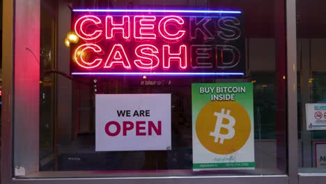 Chicago,-IL-USA--December-25th-2022:-video-footage-of-a-bitcoin-logo-signage-in-a-window-of-a-local-currency-exchange-located-in-Chicago