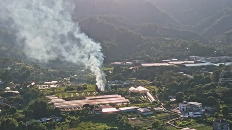 Smoke-pillar-rising-from-Farm-in-Shap-Pat-Heung,-Tai-Tong,-Yuen-Long,-Aerial-Drone-View