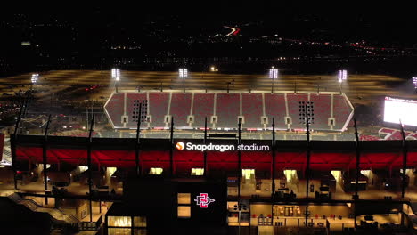 Snapdragon-Stadium-at-night-with-flood-lights-on,-drone-dolly-shot