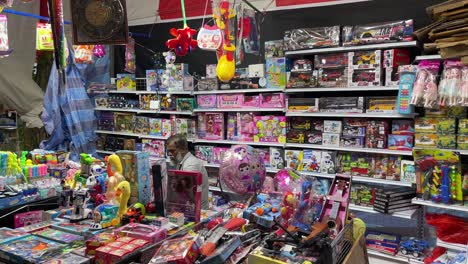 Vendors-sell-toys-and-await-customers-at-the-local-Pasar-Malam,-the-night-market-in-Bishan,-Singapore