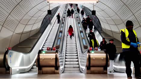 Public-commuters-using-Bond-street,-London-underground-subway-escalator-at-Hanover-Street