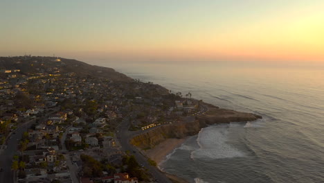 Drone-flying-over-scenic-Sunset-Cliffs-in-San-Diego,-California-at-sunset