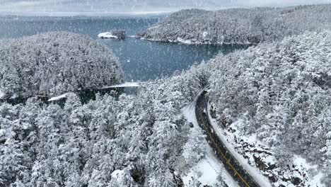 Rising-aerial-view-of-snow-falling-on-Fidalgo-Island-and-Bowman-Bay