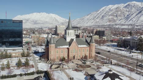 Mormon-temple-church-in-Provo-city-in-winter,-Wasatch-mountains-beyond