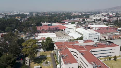 Aerial-view-passing-over-academic-buildings-at-the-University-of-Mexico's-main-campus