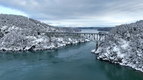 Wide-establishing-aerial-view-of-Deception-Pass-bridge-during-winter-time