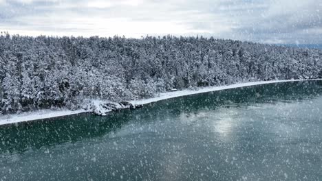 Aerial-view-of-Whidbey-Island's-shoreline-with-snow-actively-falling