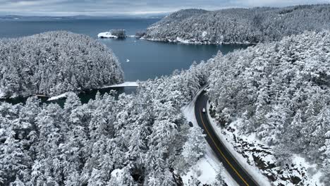 Rising-aerial-view-of-Bowman-Bay-and-Fidalgo-Island-covered-in-fresh-snow