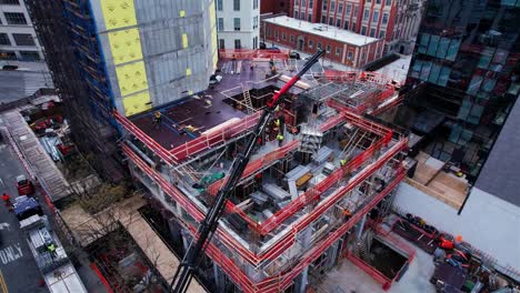 Aerial-view-of-a-crane-lifting-materials-to-a-construction-site-in-urban-New-York