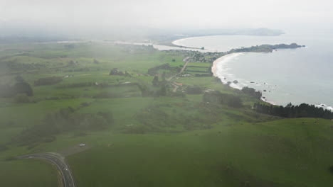Bay-of-Huriawa-Historic-Site-on-foggy-day,-aerial-drone-view